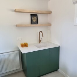 Sink unit with timber shelves mounted with steel brackets.