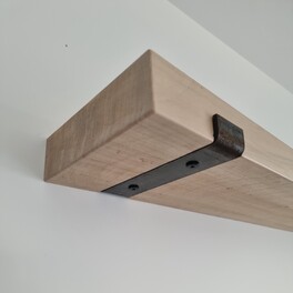 Custom timber shelving with wall brackets.
