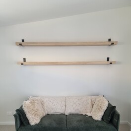 Custom timber shelving with wall brackets.