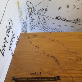 Timber table with engraving at Atlas Bar & Kitchen Queenstown.