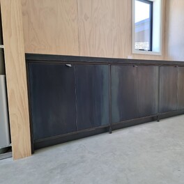  Laundry unit - hot rolled steel doors with steel framing to the face of the units. Tiled top.