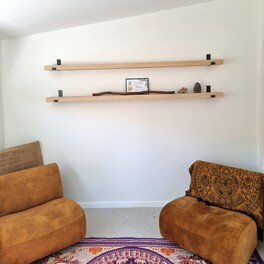 Custom timber shelving with wall brackets.