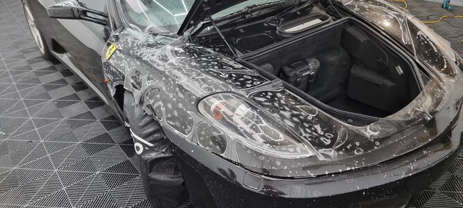 Close-up of a car hood with Paint Protection Film being applied.