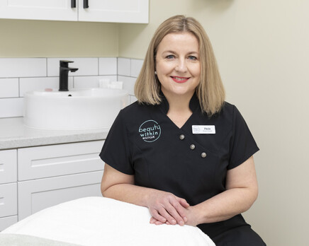 A picture of Paula sitting in the Beauty within Salon