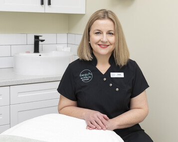 A picture of Paula sitting in the Beauty within Salon