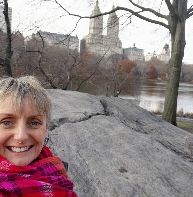 Woman in Central Park, New York wearing a bright scarf.