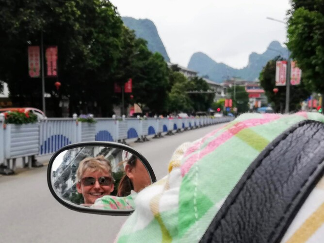 A woman on a scooter in China
