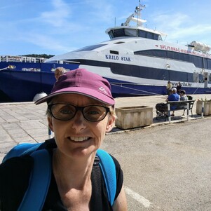 Woman standing in front of a ferry to the Dalmatian Islands.