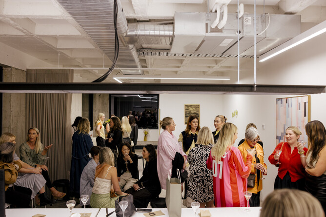 Guests networking at Biz & Sip - The Confidence Panel held at JH LAW's office in Hamilton.