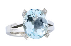 Oval aquamarine with round brilliant diamonds as accents set in 18ct white gold