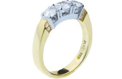 Three stone round brilliant diamond ring accented with small round brilliants - set in Platinum & 18ct yellow gold