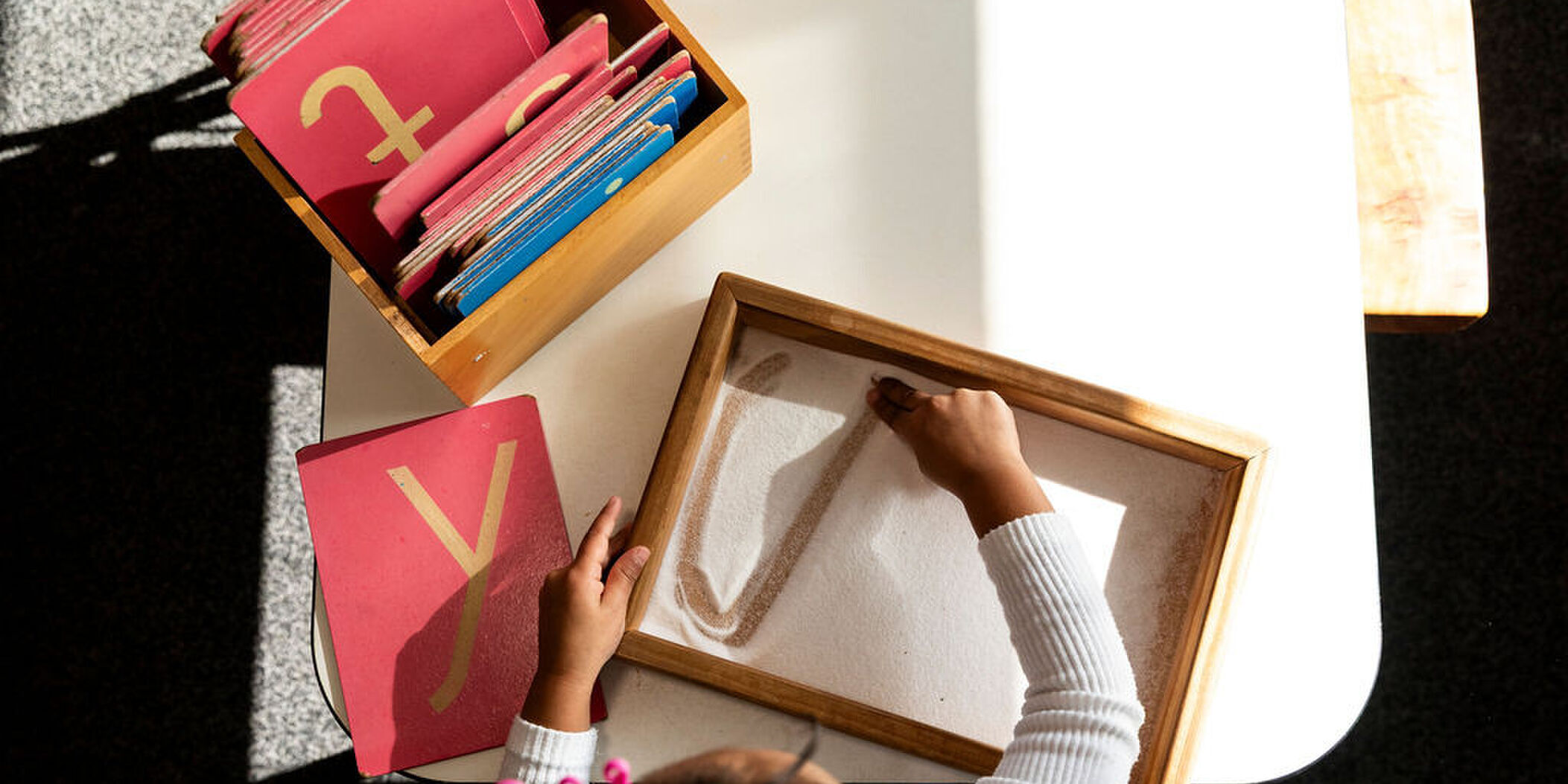 Sand letters – early phonics at Koru Montessori