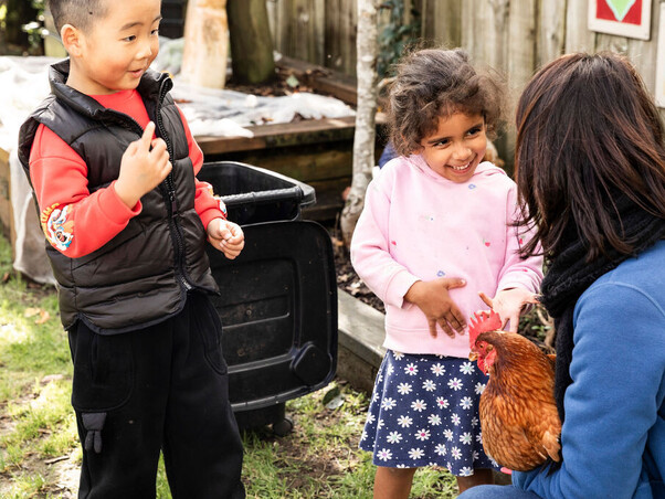 Teacher guiding child with practical life activity – North Shore