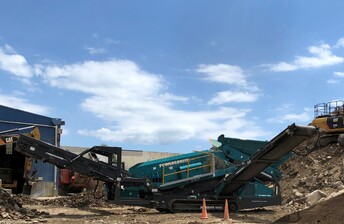 Powerscreen Warrior 1800 heavy duty screen showing 2-way split for outputting processed waste concrete