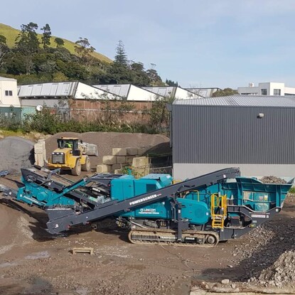 A Powerscreen Trakpactor 260SR impact rock crusher working on crushing waste concrete
