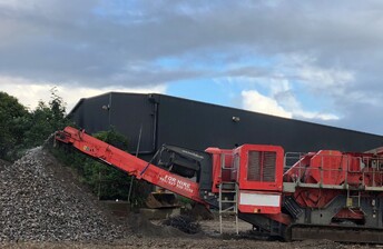 A Terex Finlay Jaw crusher machine outputting crushed waste concrete aggregate into a stockpile