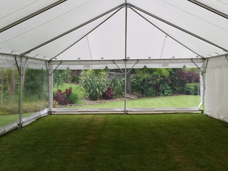 Empty white marquee on grass field – marquee only hire Auckland