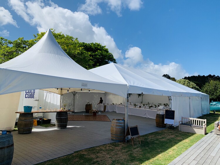 Team event in fully set up marquee with AV equipment, tables, and catering stations – Auckland corporate marquee packages