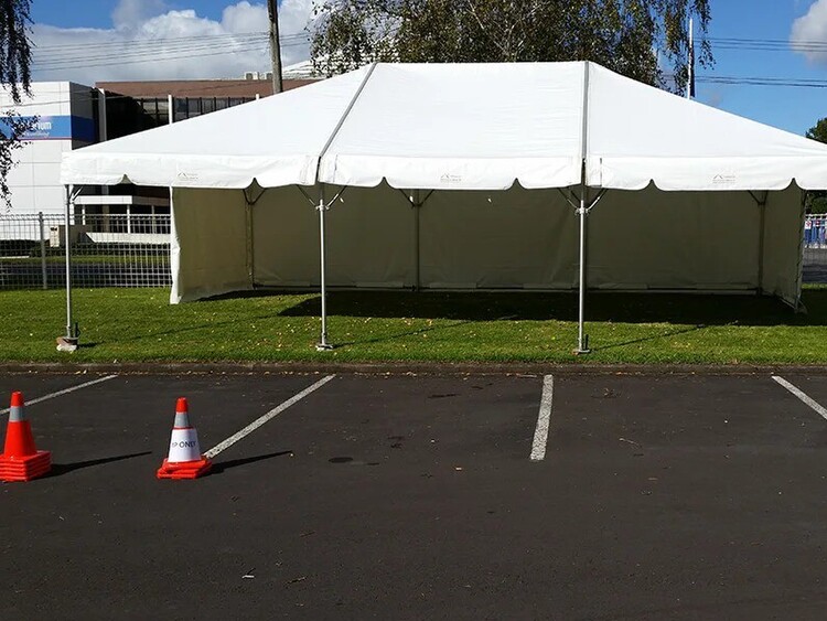 Empty white marquee on grass field – marquee only hire Auckland