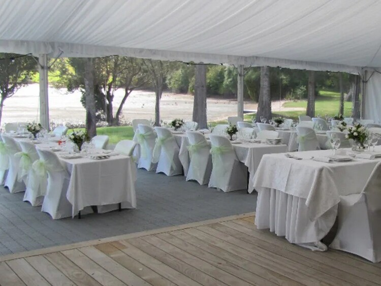 Long trestle table dining setup under fairy lights – marquee dining furniture hire Auckland