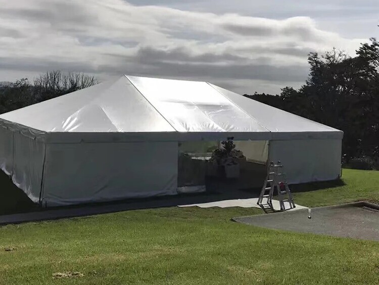 Empty white marquee on grass field – marquee only hire Auckland