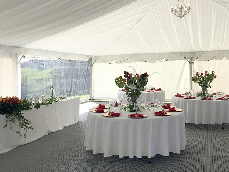 Round tables with white linen and floral centrepieces – wedding round table hire Auckland