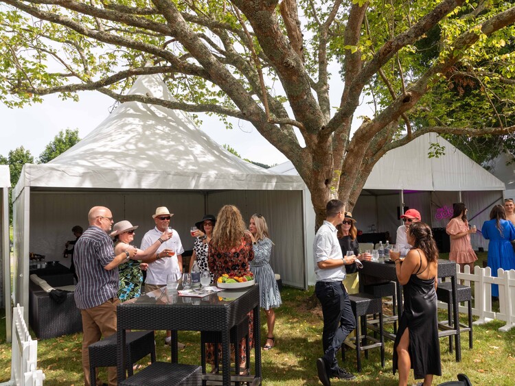 Full garden party setup with marquee, lounge area, umbrellas, and bar – private event marquee hire Auckland