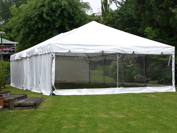 Empty white marquee on grass field – marquee only hire Auckland