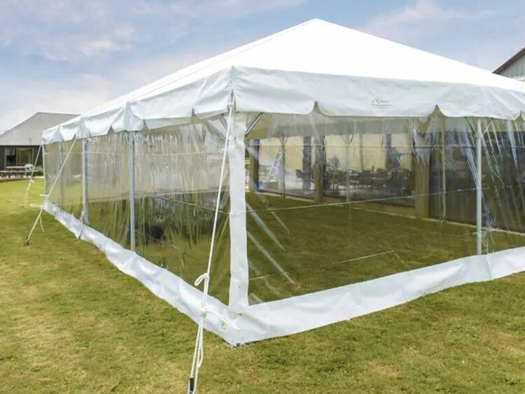 Empty white marquee on grass field – marquee only hire Auckland