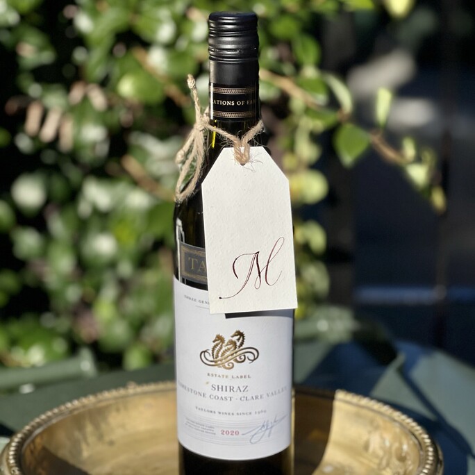 An M gift tag for Murray attached to a shiraz his favourite red wine