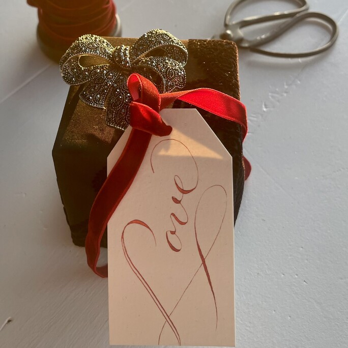 An engagment gift featuring our love gift tag in ruby ink with a vibrant velvet ribbon. It has its own love note on the back of the tag.