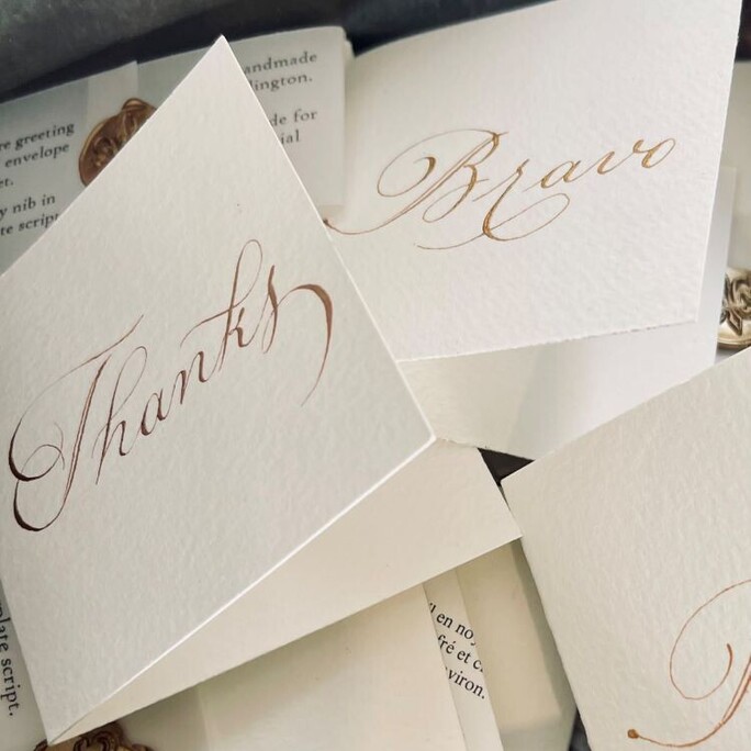 A stack of our mini card and envelope sets waiting to be sold in a preloved cake tin