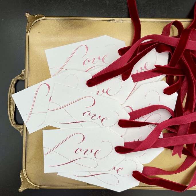 A collection of our beautiful love gift tags hand written in ruby red with a burgundy velvet ribbon which takes its name 'burgundy' from the burgundy wine in France