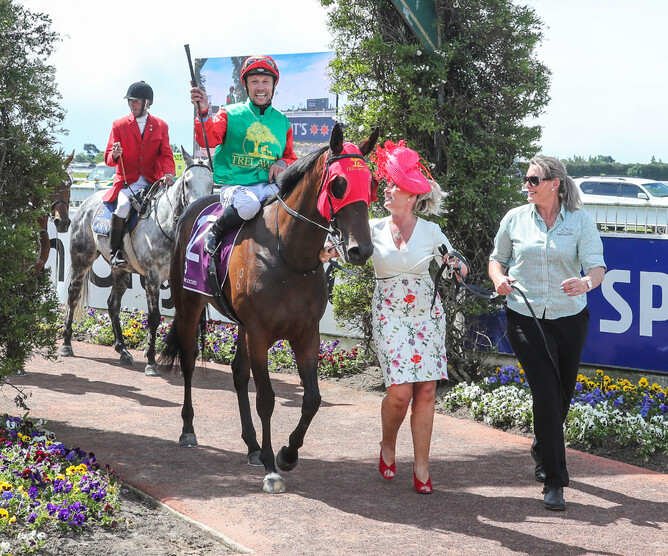 Breeder and part-owner Cherry Taylor (red hat) leads in a jubilant Michael McNab aboard Loire at Riccarton. Photo credit: Race Images South