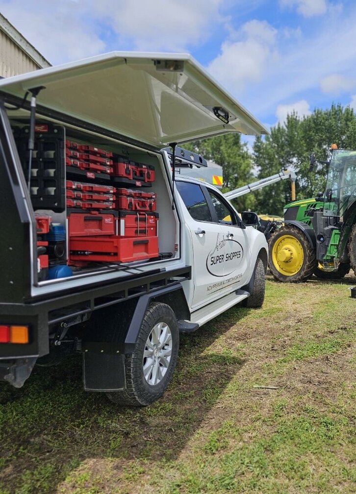 Truck and tractor parked in a paddock