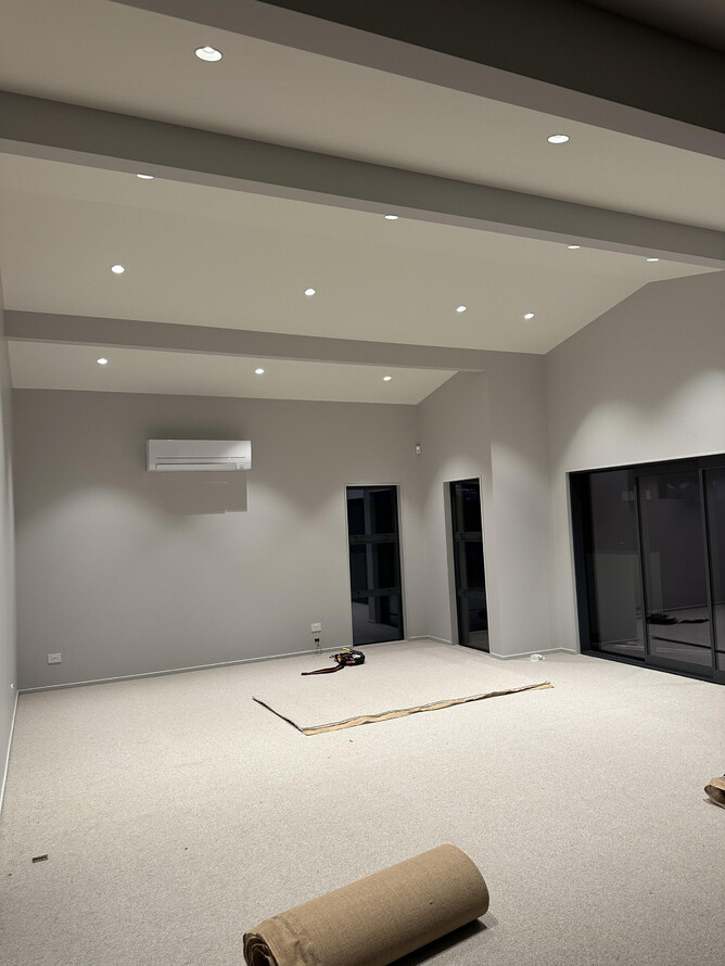 ownlights integrated into custom ceiling in lounge of Maungatapu new build
