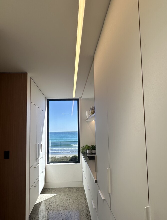 Walk-in robe with ceiling light strip and ocean view