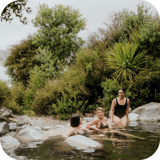 People relaxing in the Deluxe Lake Spa pools at Polynesian Spa overlooking Lake Rotorua