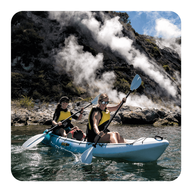 Waimangu Valley, Rotorua, kayaks on the water near cliffs