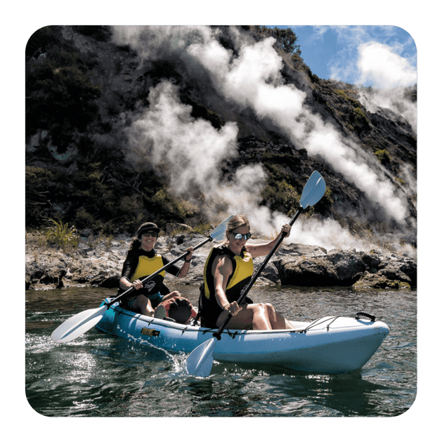 Waimangu Valley, Rotorua, kayaks on the water near cliffs