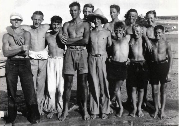 Twelve foundation members of the Wakatere Canoe Club after a sailing race in 1928. Left to right - Ron Hunt, Bert Williamson, Sid Ivill, John Brooke, Warren Bond, Sid Lydford, Owen Probert, Bon Grut, Jack Hunt, George Kemp, Roy Lockwood and John Gordon.