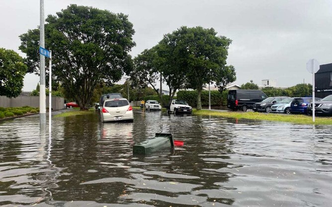 Flooded street with cars and trees, symbolising challenges in leadership and crisis management