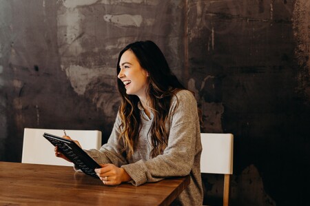 Woman smiling during a meeting, representing GGA's focus on shared success and board efficiency