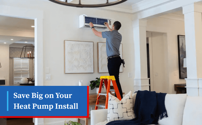 Technician on ladder installs a ductless mini-split heat pump indoors.
