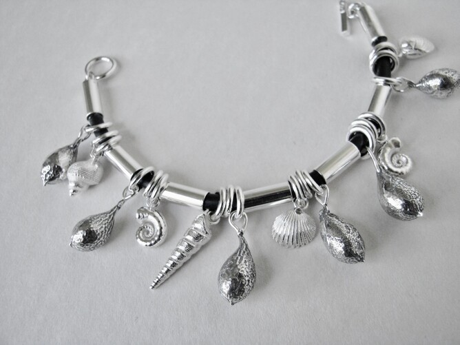 Bracelet of sterling silver shells, seaweed pods and links on neoprene. Made to order