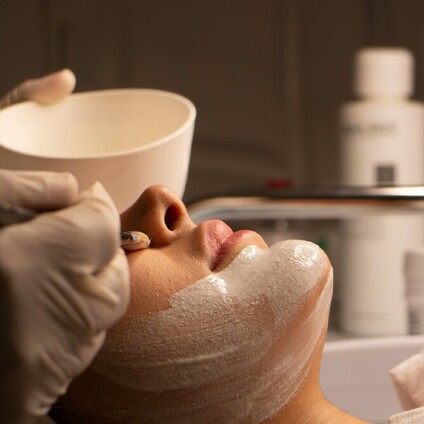 A couple relaxing on a couch in robes ready for their Indulge Mobile Spa treatment.