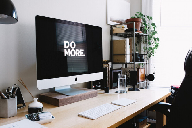 Computer screen with a 'do more' motivation quote on it - Photo: Carl Heyerdahl, Unsplash