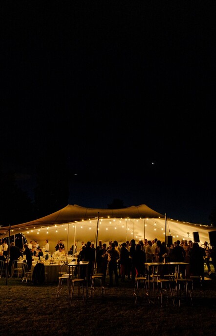 Wedding Styling of a marquee tent at night with globes lit by The Event Girl