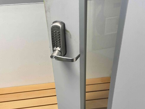 a commercial codelock installed on an open door.