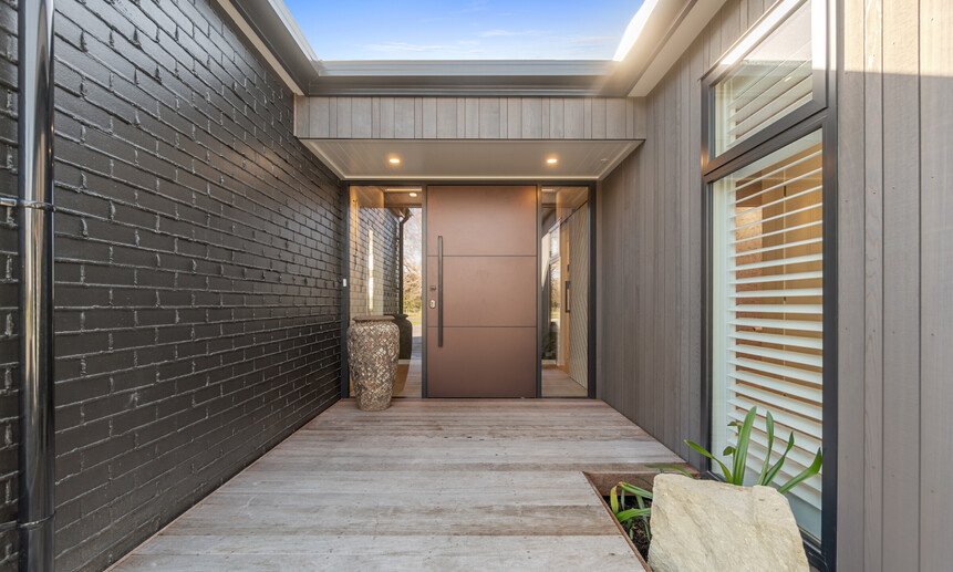 Architectural front entrance with statement door makes for a bold entry in this Master Builder House of the Year Gold winner.